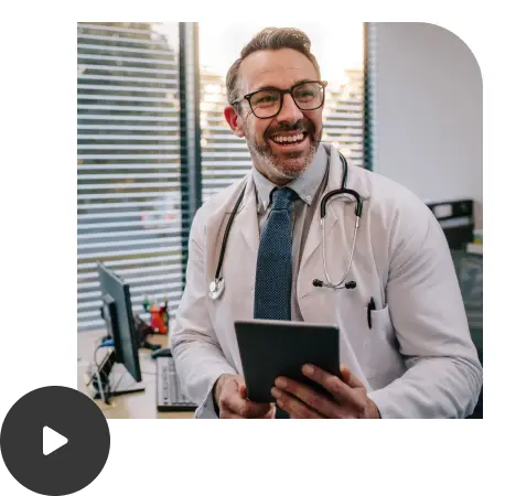 A doctor is holding a tablet and happy because he got answers to his medical questions.